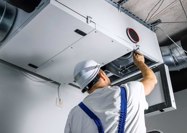 hvac engineer install heat recovery ventilation system for new house. copy space hvac engineer install heat recovery ventilation system for new house. copy space